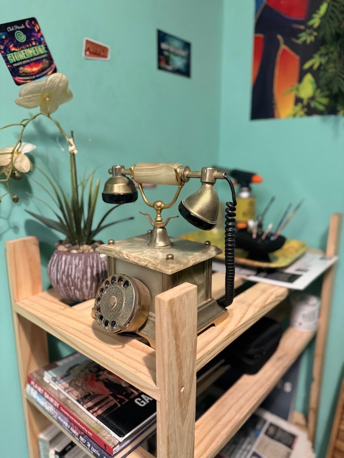 Vintage brass telephone beside the rosin press