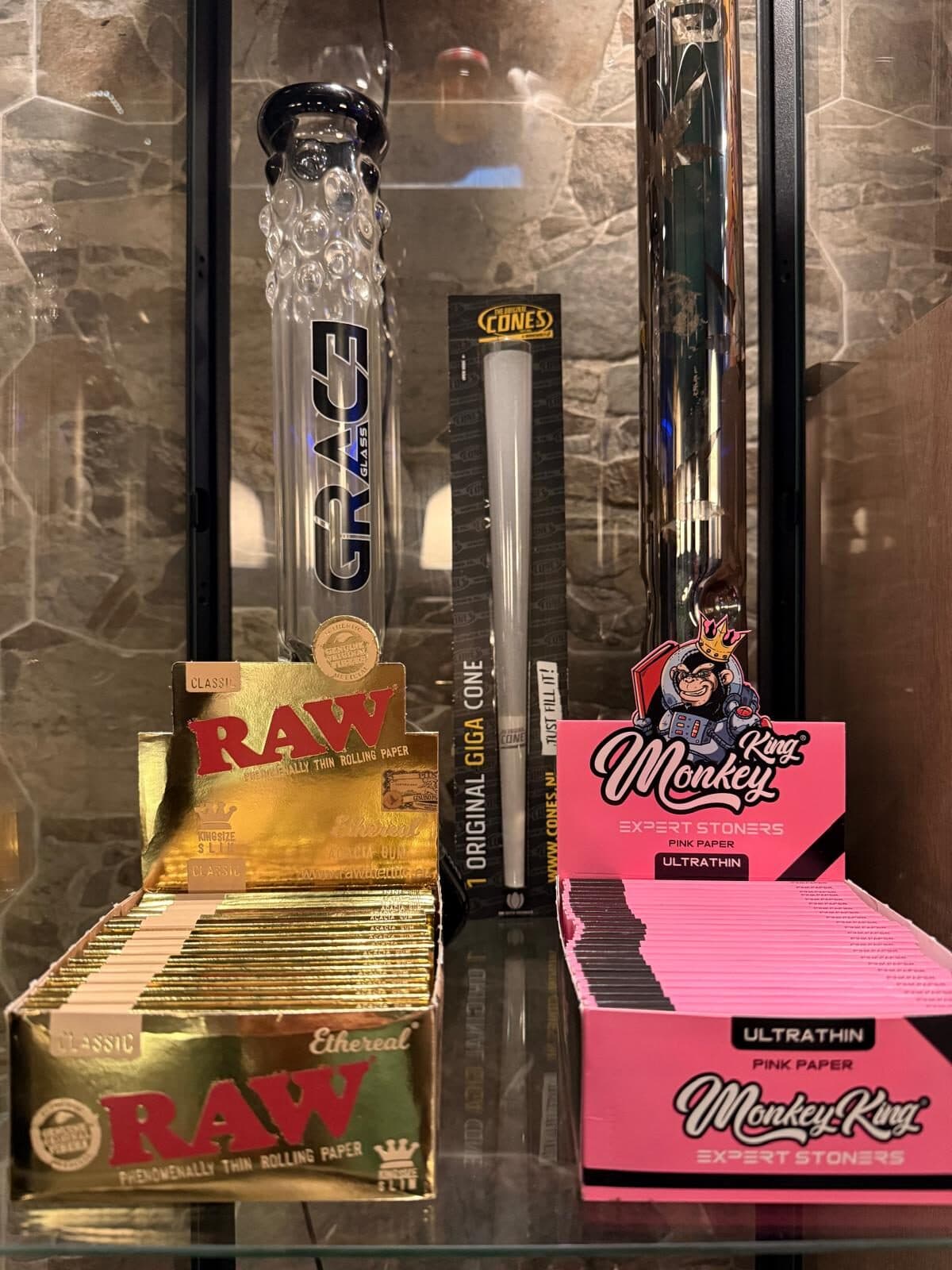 Grace glass bong beside the RAW rolling paper display