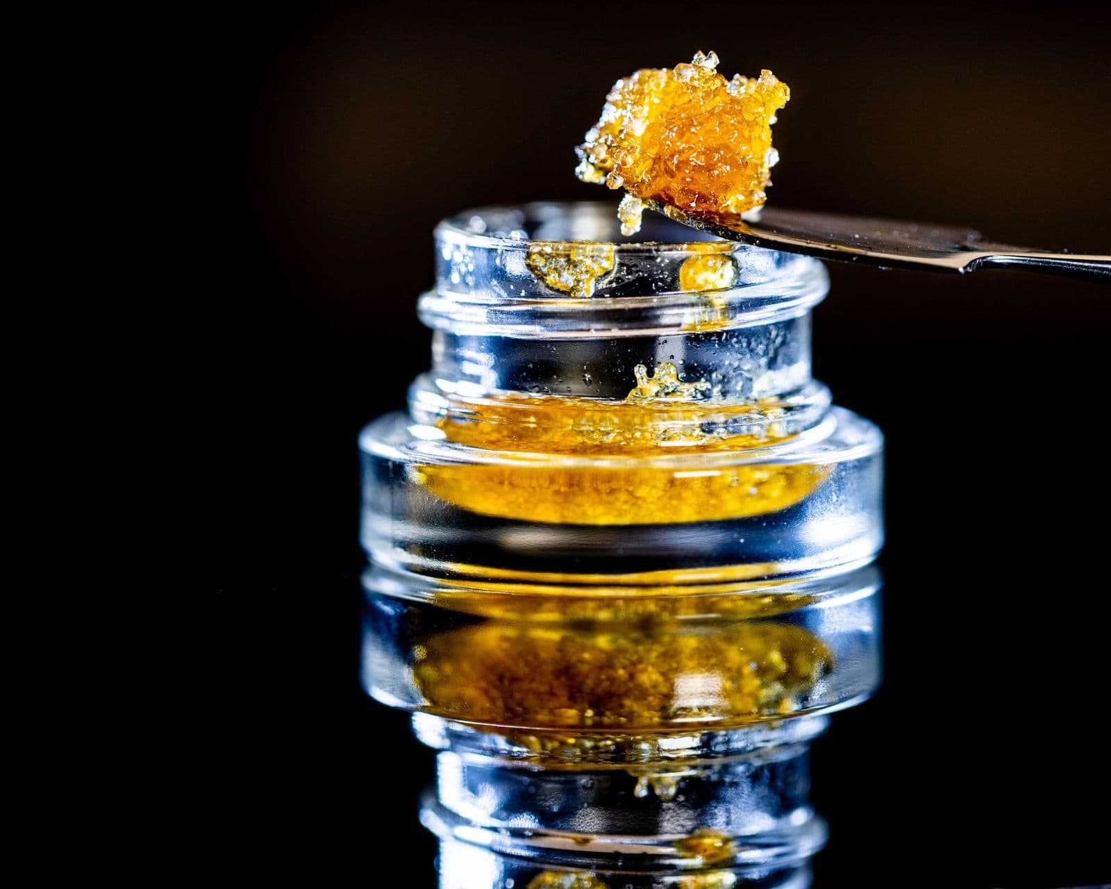 Golden cannabis extract in a glass jar